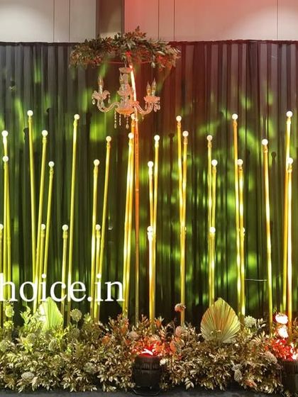 This image shows our sangeet stage with dynamic lighting. The green light projected onto the gold pillars creates a different mood, showing how we can change the ambiance with our lighting design.