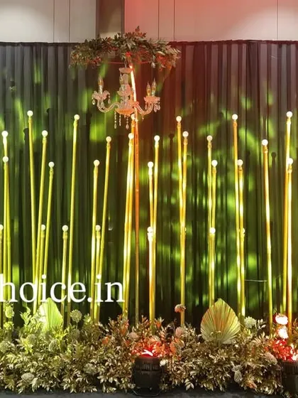 This image shows our sangeet stage with dynamic lighting. The green light projected onto the gold pillars creates a different mood, showing how we can change the ambiance with our lighting design.