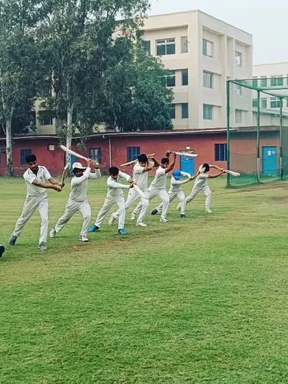 Players practicing the full range of motion for a cover drive during a group drill session.