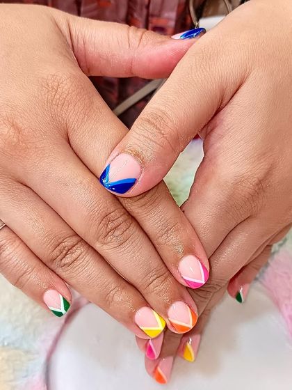 Another angle of the playful, colorful geometric French tips on natural nails, showing how a pop of color can make a big impact.