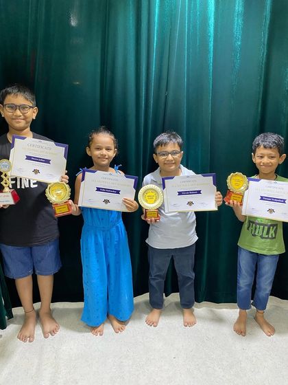 A group of our abacus achievers, proudly displaying their certificates and trophies after the prize distribution.