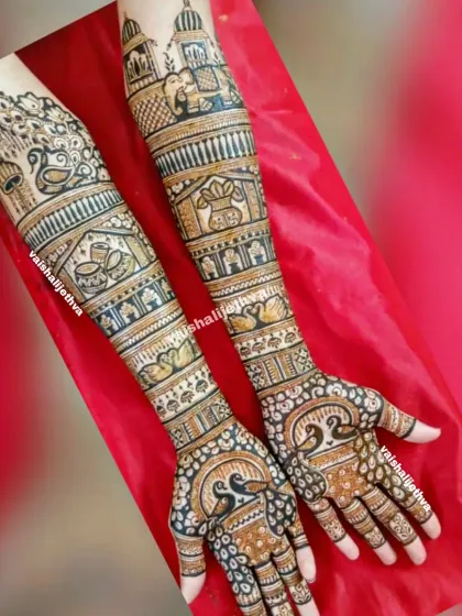 A full-arm bridal design rich with traditional elements. The artwork includes kalash, elephants, swans, and peacocks, all tied together with intricate patterns.