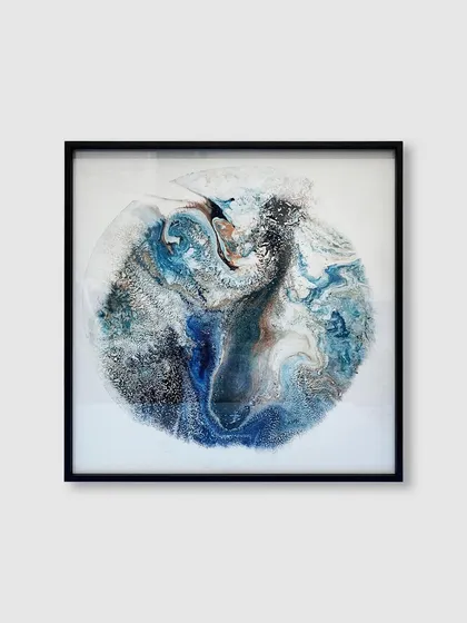 This captivating abstract piece, reminiscent of a planet or a marble, is given a sleek and modern finish with our minimal black metal frame.