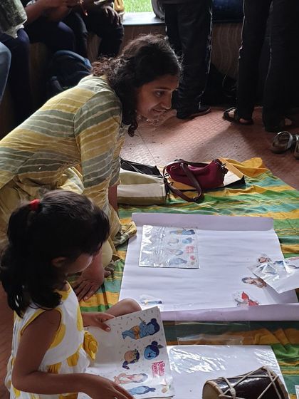A mother and daughter work together on a sticker activity. Our sessions are designed to encourage parent-child collaboration and shared creative moments.