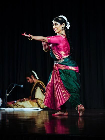 Performing a traditional Varnam at the Delhi International Arts Festival. The live orchestra on stage, including vocals and mridangam, is essential for creating an immersive experience.