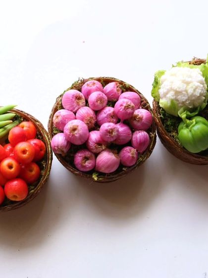 Three baskets of my miniature vegetables: tomatoes and beans, onions, and cauliflower and capsicum.