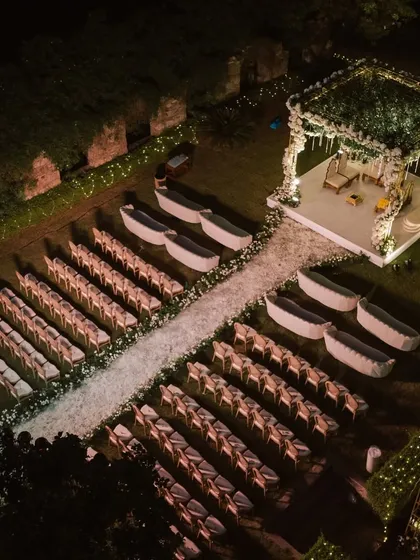 This aerial view showcases the scale and symmetry of an outdoor wedding setup I designed. The carefully arranged seating, the pristine white aisle, and the beautifully constructed mandap create an organized and visually stunning experience for all guests.