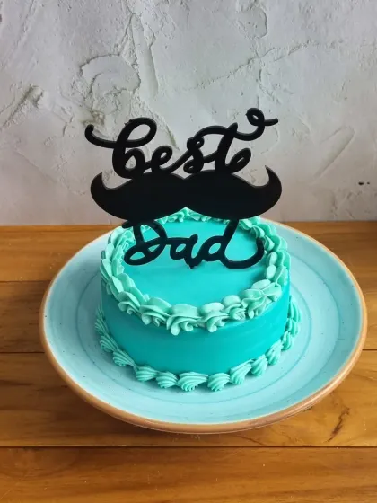 A close-up of our popular "Best Dad" cake with the mustache topper, a fun and stylish choice for Father's Day.