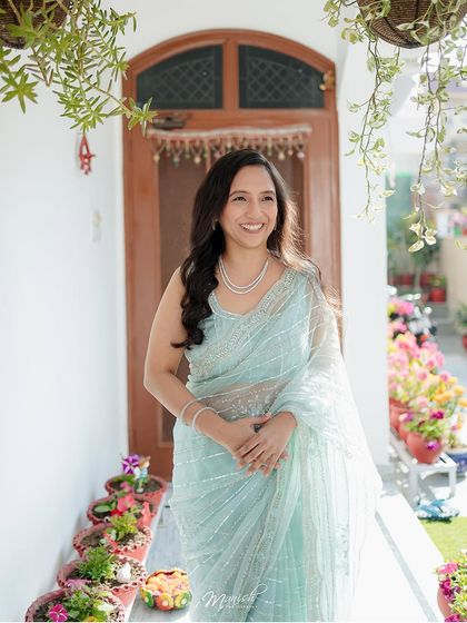 A happy, candid portrait of the bride-to-be, her genuine smile captured in the warm, natural light of her home.