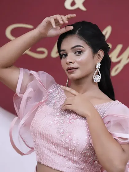 A graceful pose that shows the entire look coming together, from the makeup and hair to the outfit and accessories.