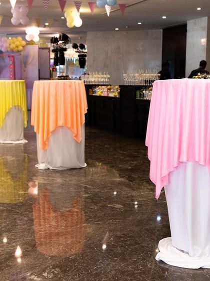 Colorful high-top tables for guests to mingle and enjoy refreshments.