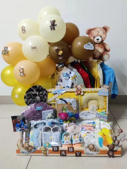 This teddy bear themed trousseau is filled with essentials for a newborn. I've used a neutral brown and yellow color palette, with cute bear details and balloons, making it a warm and cuddly welcome gift.