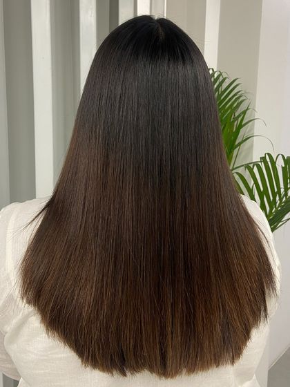 A back view showcasing the sleek, uniform finish of a hair smoothening treatment. Notice the healthy shine and the perfectly straight ends.