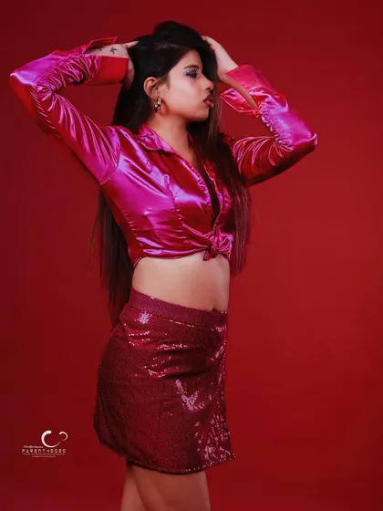 A more dynamic pose with hands in her hair. This shot captures a moment of freedom and confidence.