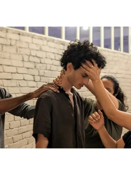 Our workshops go beyond typical team-building. We use somatic techniques to help team members connect on a deeper level, offering support and building empathy. This image captures a moment of profound, non-verbal communication and collective care.