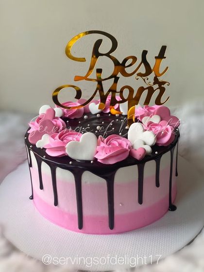 A beautiful ombre pink drip cake for the "Best Mom." The chocolate drip and piped hearts make it a sweet and loving gesture for Mother's Day.