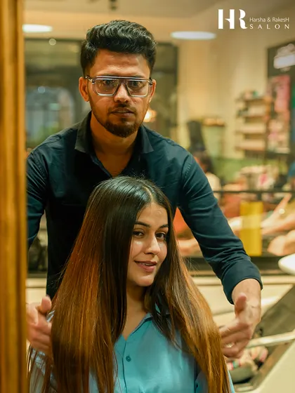 A happy client seeing her transformed hair. After a Hair Botox treatment, her hair is visibly smoother and healthier, and our stylist is there to ensure the final look is absolute perfection.