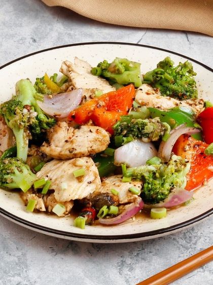 A healthy and flavourful option of tender chicken pieces stir-fried with fresh broccoli, onions, and bell peppers in a light sauce.