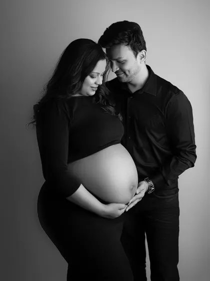 A beautiful black and white portrait showing the couple's hands cradling her bare belly. It’s an adorable and intimate shot that celebrates their journey.