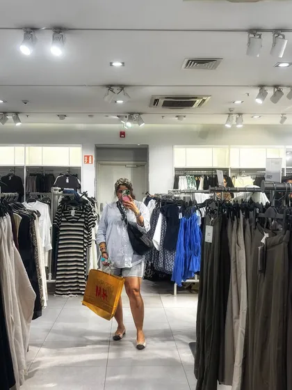 A wider shot of the same shopping outfit, showing the store environment.