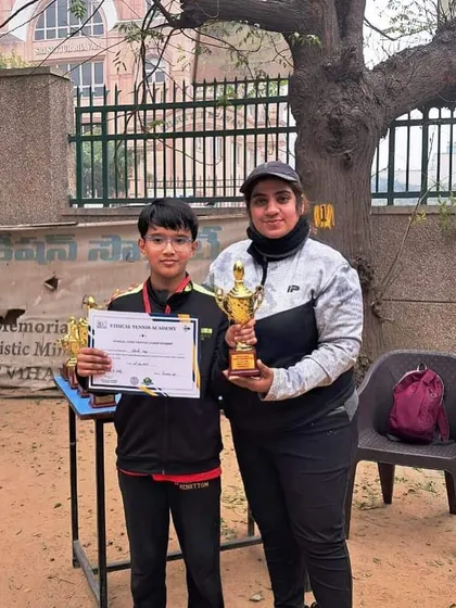 Advik Negi from our Saket center after reaching the U-10 finals at the Delhi Open Dream Catchers Tournament. He is seen here with his coach, holding his trophy and certificate.