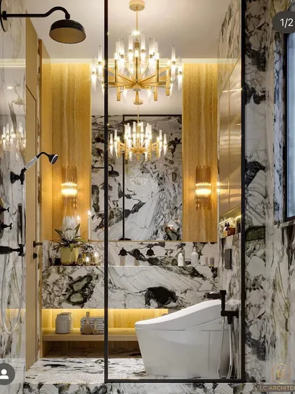 A truly opulent bathroom design. This space is wrapped in dramatic marble, with a grand crystal chandelier and gold accents creating an atmosphere of pure luxury.