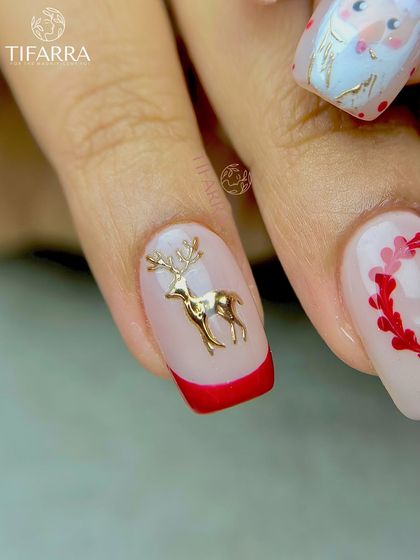 A close-up of a 3D golden reindeer embellishment, a perfect example of our detailed festive nail art.