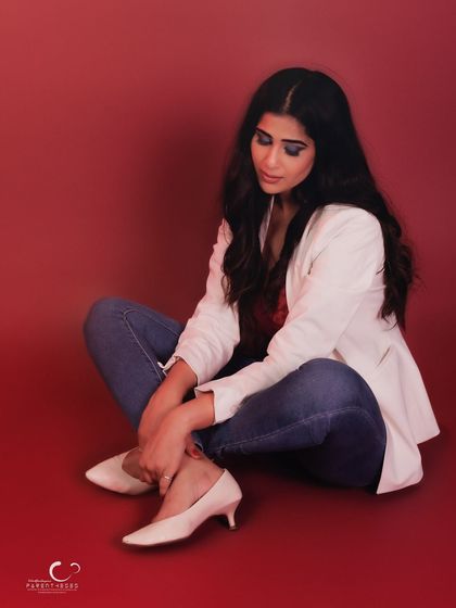 A quiet, contemplative moment captured in the studio. The soft lighting and her downward gaze create a serene and beautiful portrait.
