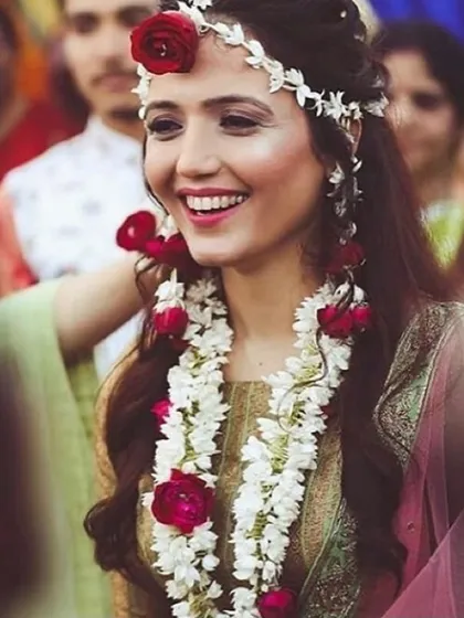 This is a custom floral jewellery set I made for a bride, featuring a maang tikka, necklace, and earrings with white mogra and vibrant red roses. I design these pieces to match your outfit and personal style for any pre-wedding event.