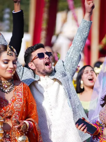 The energy of a baraat is infectious! I focus on capturing that raw, unfiltered joy, like this shot of the groom and his friends celebrating with full enthusiasm. These are the candid moments that truly define the celebration.