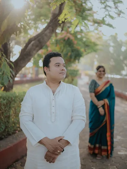 A creative portrait with the groom in the foreground and the bride softly focused in the back. It tells a story of anticipation and love.