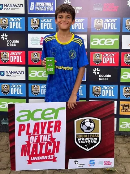 A U13 player, Yug, proudly holds his "Player of the Match" award. A true team player who has been with us for 5 years, his success is a testament to his versatility and commitment.