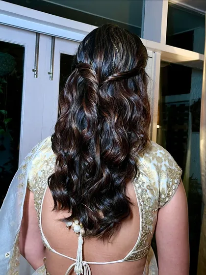 A detailed look at the soft, twisted half up-do hairstyle that perfectly completes this classic bridesmaid look.