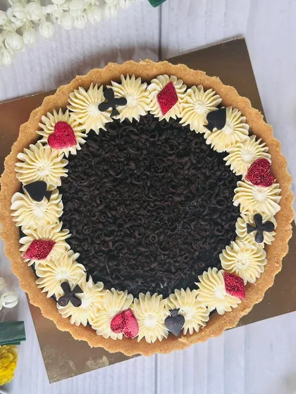 Perfect for a Diwali card party, this chocolate tart is decorated with the four card suits. It's a fun, festive, and delicious treat to share while playing.