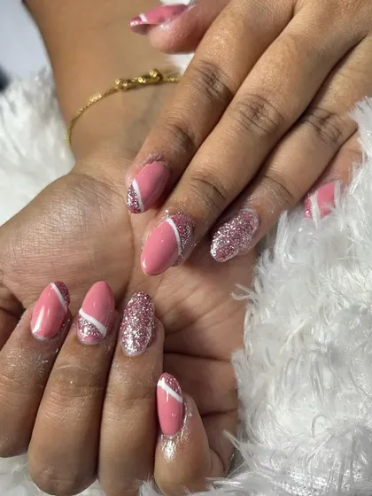 Another angle showing the abstract white lines over the pink base, paired with a full coverage pink glitter nail. This is a fun way to combine different textures and finishes.