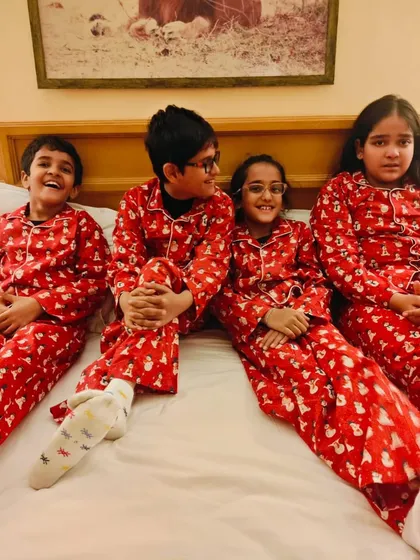 A group of kids all ready for bed in their matching red Christmas pyjamas. It's so heartwarming to see them enjoying the festive season together.