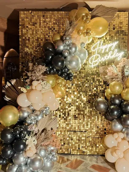 The party never stops, even when it rains. We love creating these glamorous birthday setups, like this one with a gold sequin wall and a beautiful balloon arrangement, ensuring the celebration shines no matter the weather.