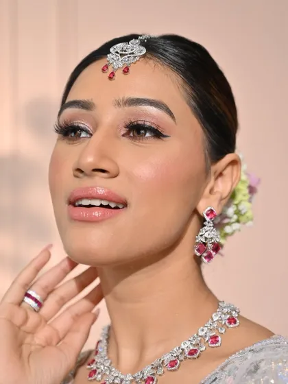A close-up focusing on the flawless skin and soft pink lips. This look is a perfect example of modern minimalism, where the makeup enhances rather than masks.