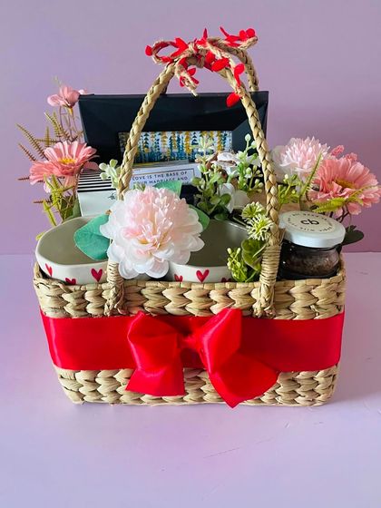 The attention to detail, from the tiny hearts on the mugs to the floral arrangement, makes this couple's hamper truly special.