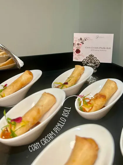 Corn Cream Phyllo Rolls, a crispy and creamy appetizer, elegantly served for an anniversary celebration.
