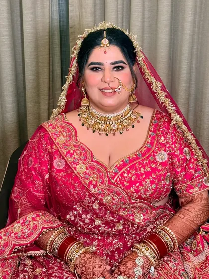 The beautiful bride Shrishti, all smiles for her pheras. Her makeup is classic and timeless, with a focus on flawless skin and expressive eyes.