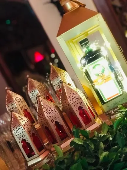 Another angle showcasing the creative use of lighting in my Sufi theme. A collection of intricate red and gold Moroccan lamps surrounds a lantern holding a bottle, creating a warm and inviting glow.