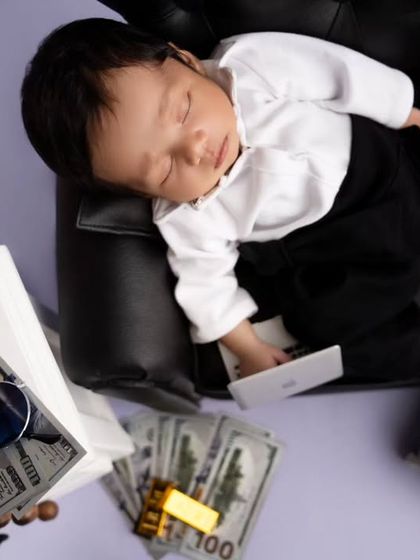 An overhead shot of the Boss Baby, showing off all the fun props like play money, sunglasses, and a mini smartphone.