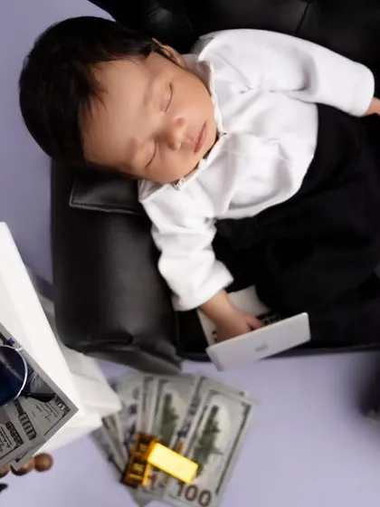 An overhead shot of the Boss Baby, showing off all the fun props like play money, sunglasses, and a mini smartphone.