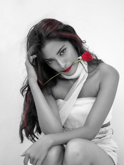 A different pose from the 'Only Red' series, again using the color splash effect. The technique highlights the model's expression and the single red rose she holds.