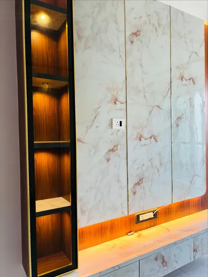 A detail shot of the marble-finish TV unit, showing the lit display niche. These small details are what elevate a simple piece of furniture into a luxury statement.