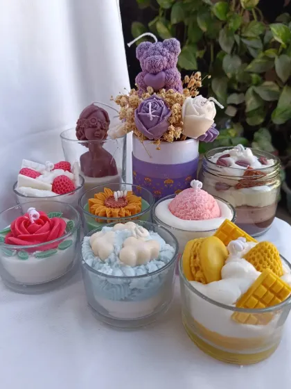 A delightful collection of my dessert-inspired candles. This image showcases the variety I offer, from ice cream and waffle candles to tiramisu jars and flower-topped treats.