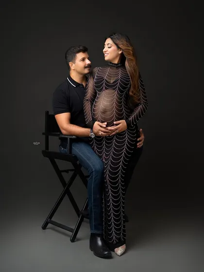 A stylish and modern couple's portrait. The mamma looks stunning in the embellished gown, and the pose is full of connection.