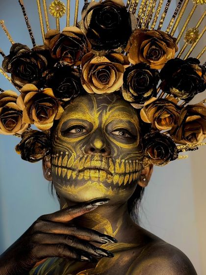 A powerful close-up of the golden skull, highlighting the detailed teeth and floral headpiece.