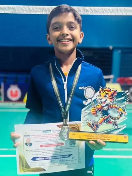 Aadiraj Shetty beaming with his runner-up trophy from the Boys Doubles U11 at the Mini Maharashtra State Selection Badminton Tournament.